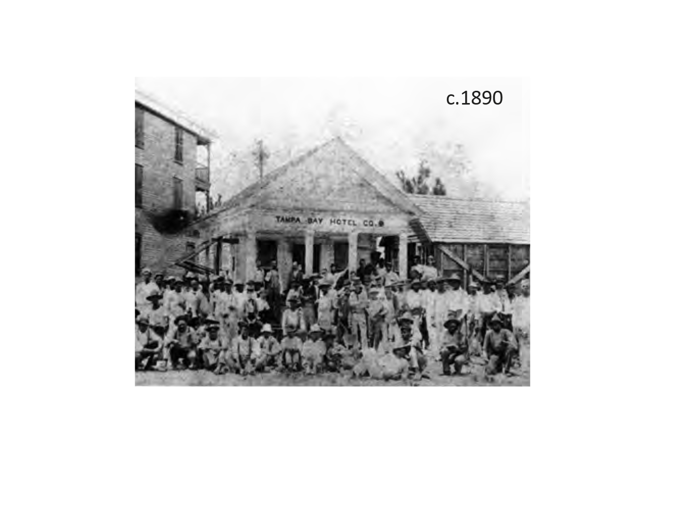 Historical black and white photo of a large group in front of Tampa Bay Hotel, circa 1890.