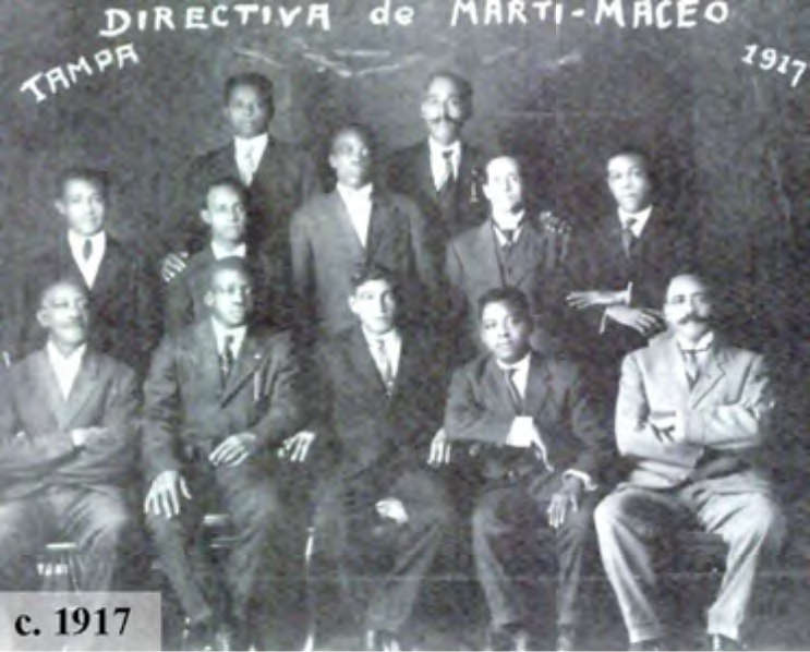 Historical group photo of the Marti-Maceo Board, Tampa, 1917, featuring twelve men in formal attire.