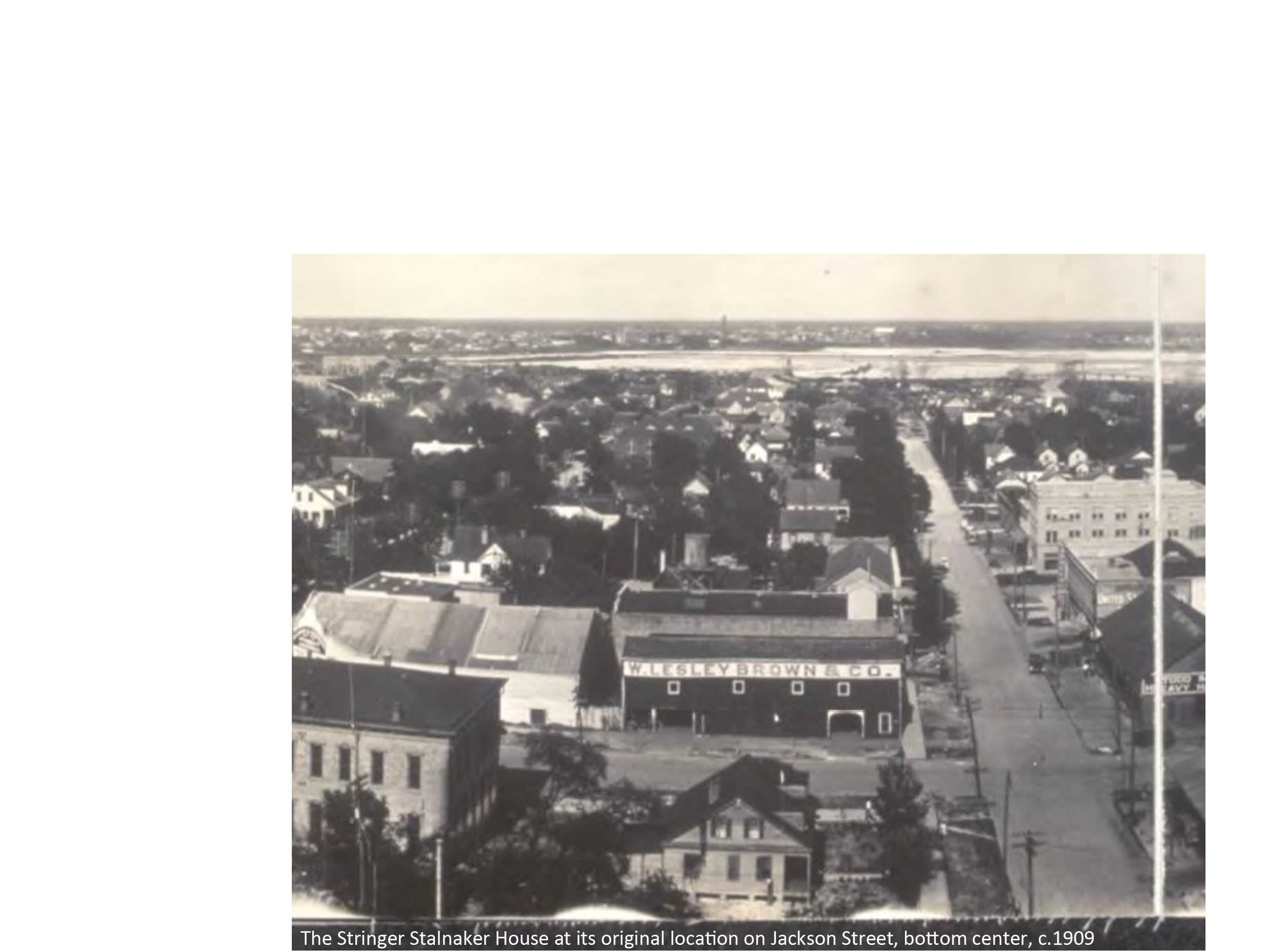 Historic aerial view of the Stringer Stainaker House on Jackson Street, surrounded by early 20th-century buildings, circa 1909.
