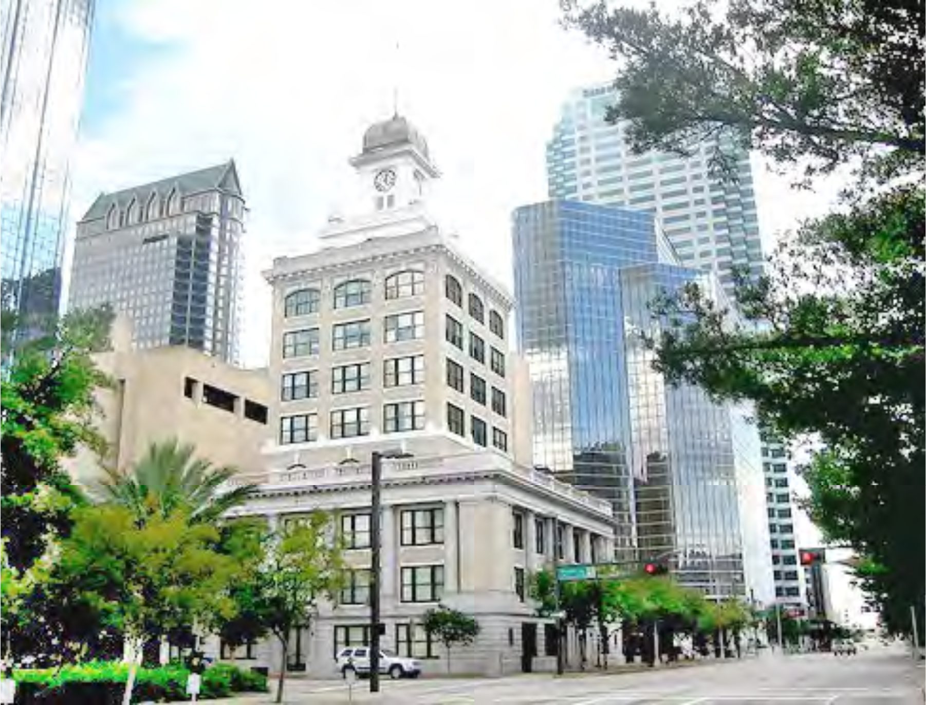 Historic building in foreground with modern skyscrapers in background, showcasing a mix of architectural styles in an urban setting.