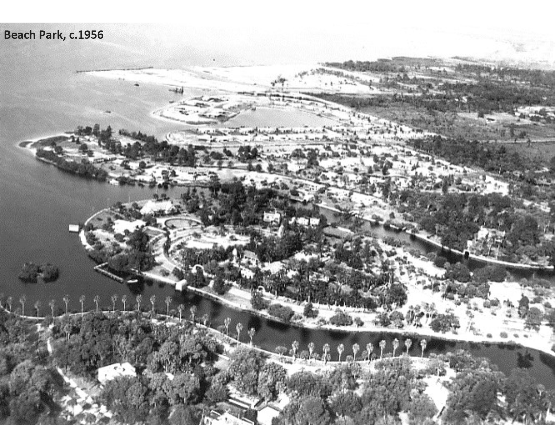 Aerial view of Beach Park in 1956, featuring lush trees, winding waterways, and park layouts amidst a panoramic landscape.