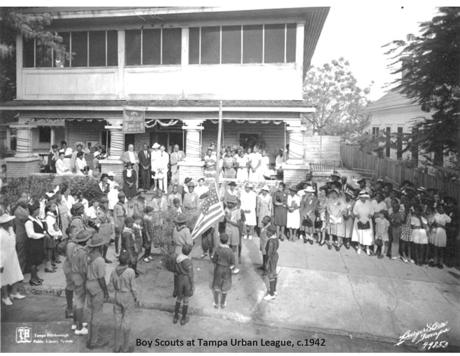 Black and white photo of Boy Scouts at Tampa Urban League, c. 1942, with adults and children gathered around.