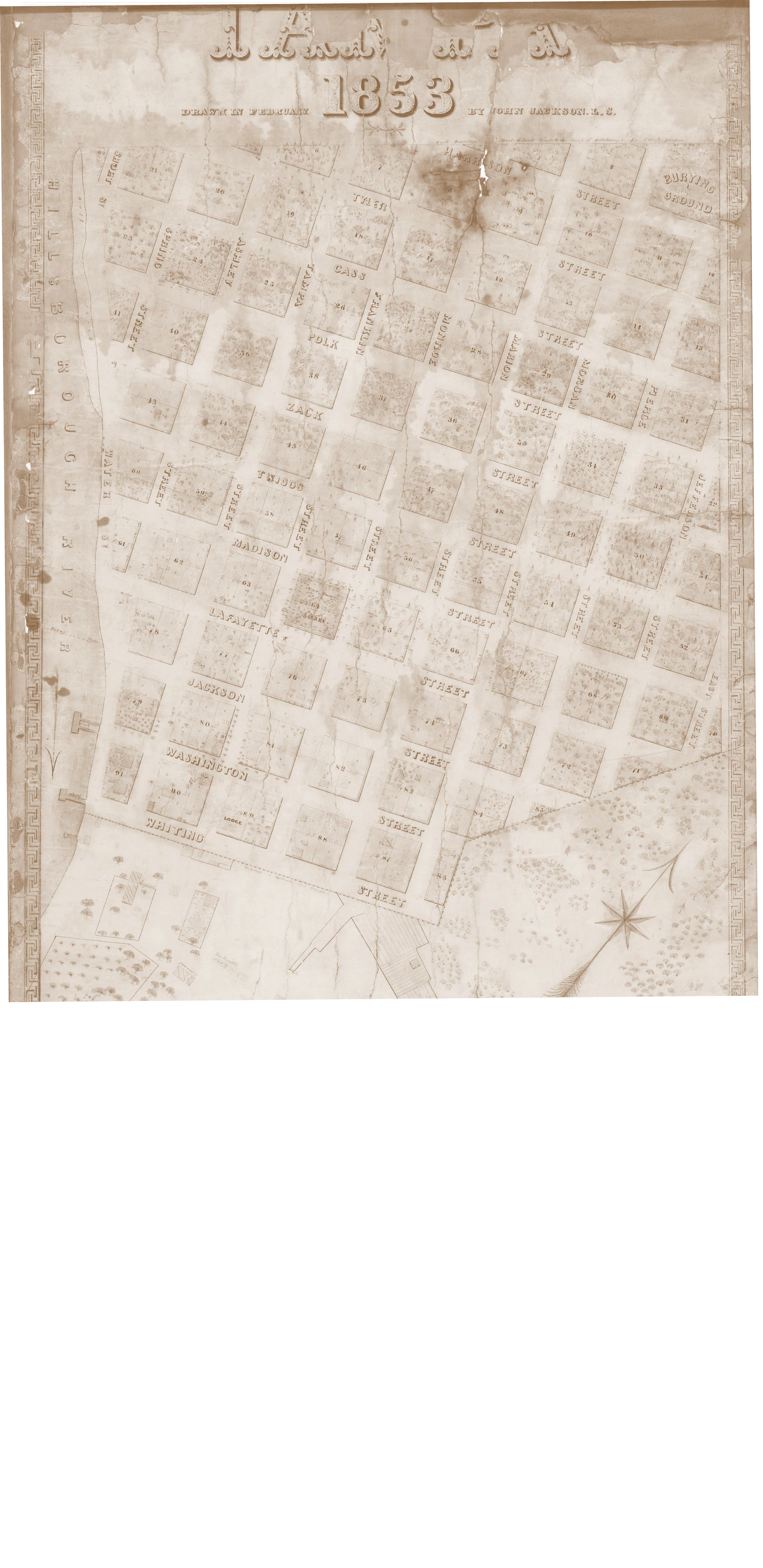 Historical map of a city from 1853, showing streets, plots, and landmarks in a detailed layout.