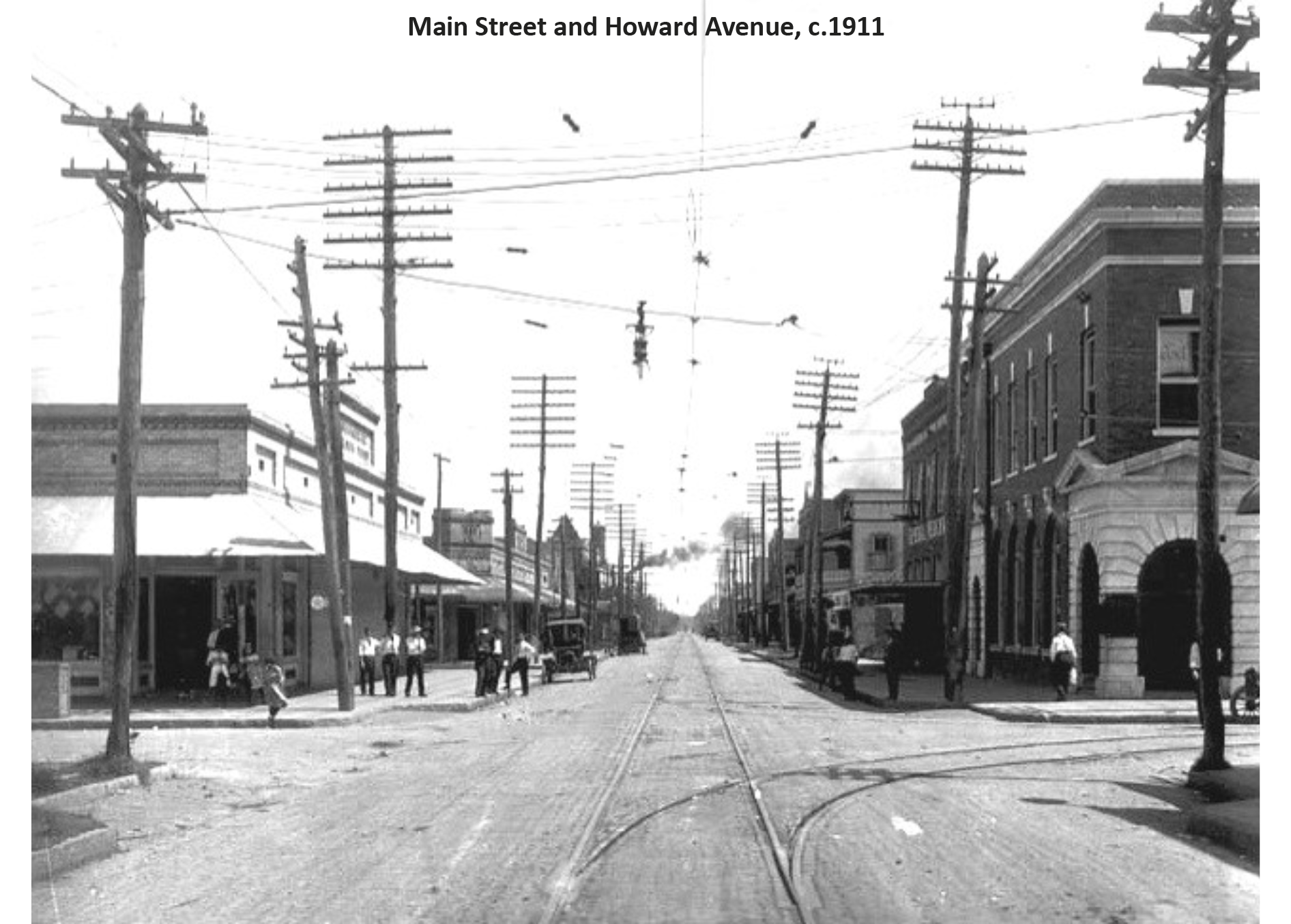 Historic photo of Main Street and Howard Avenue, circa 1911, featuring streetcars and early 20th-century architecture.