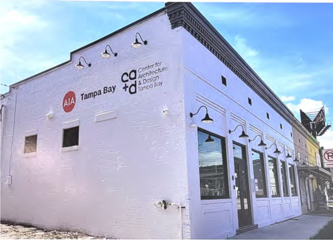 Exterior of the AIA Tampa Bay building featuring a white facade and signage for the Center for Architecture and Design, against a blue sky.