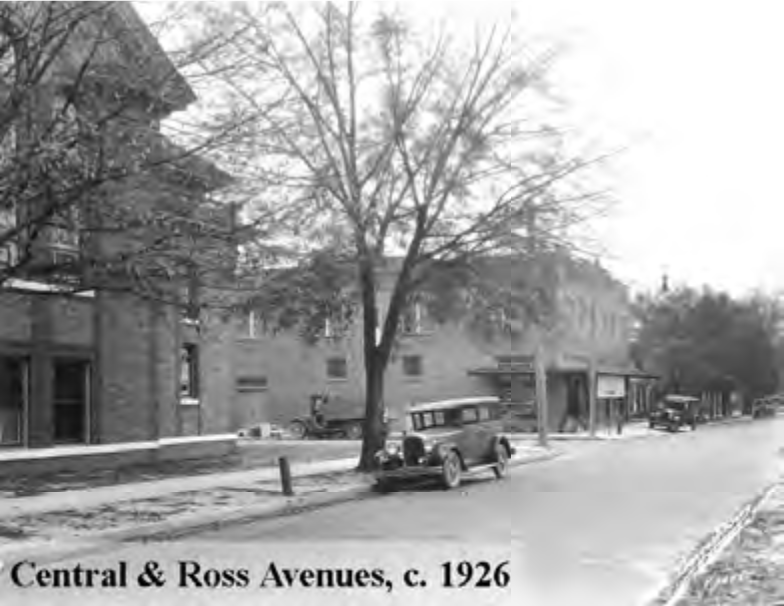 Historical black and white photo of Central & Ross Avenues, featuring early 20th-century buildings and automobiles from around 1926.