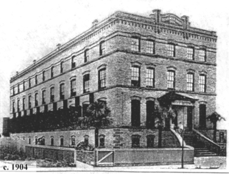 Historic black and white illustration of a four-story brick building, c. 1904, with intricate architectural details and a front entrance.