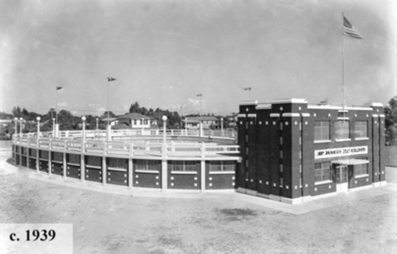 Historic black and white photograph of a circular stadium building, c. 1939, showcasing a flag and architectural details.