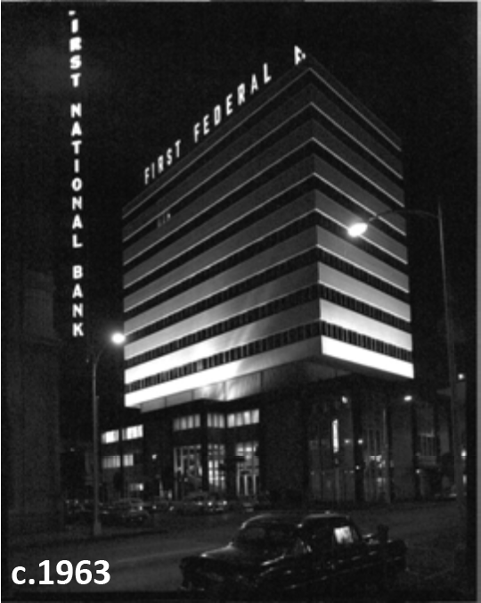 Historic black and white photo of First Federal Bank building at night, c. 1963, showcasing illuminated signage and architecture.