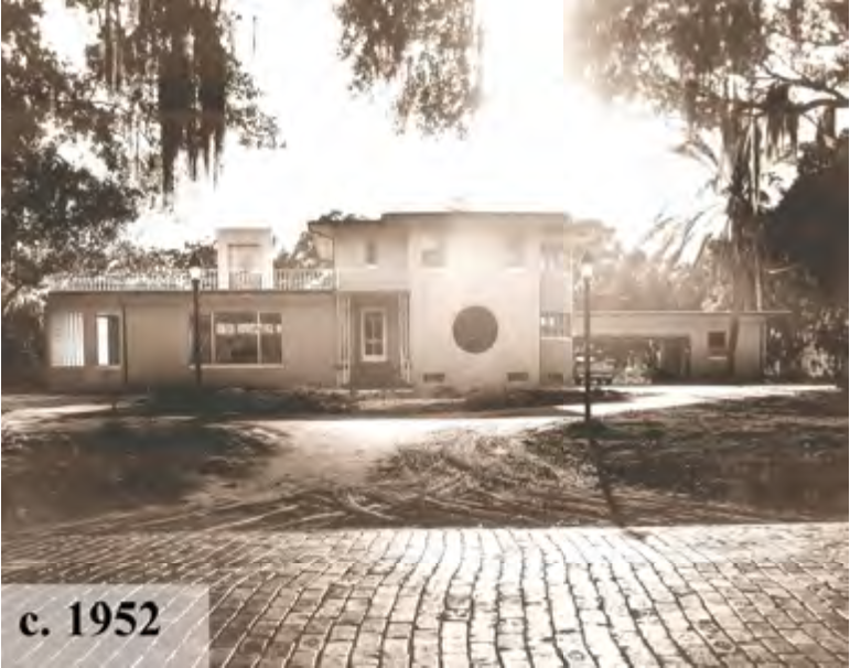 A historic house captured in a black and white photograph, dating to around 1952, set within a natural landscape.