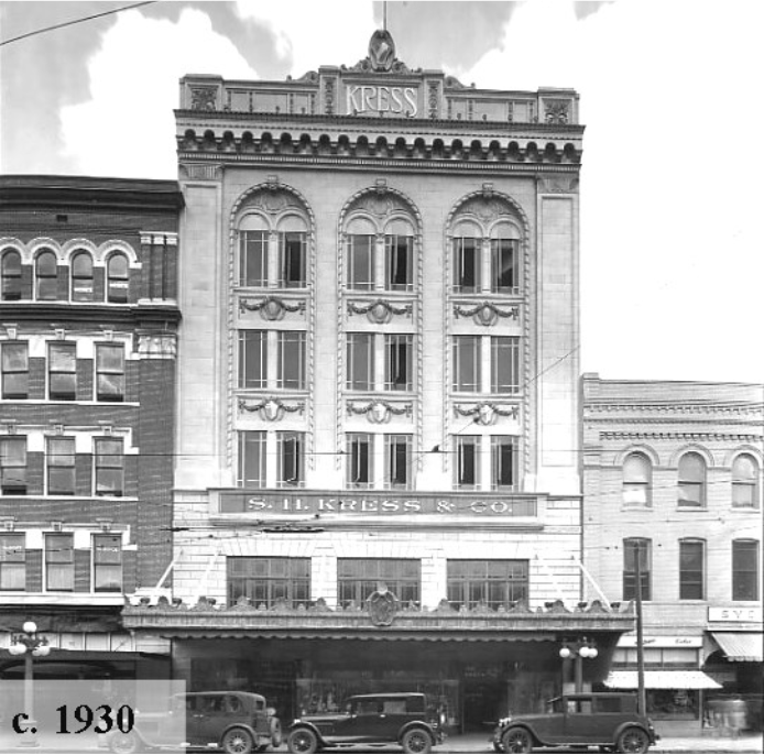 Historic black and white photo of S.H. Kress & Co. building from circa 1930, featuring ornate architecture and vintage cars in front.