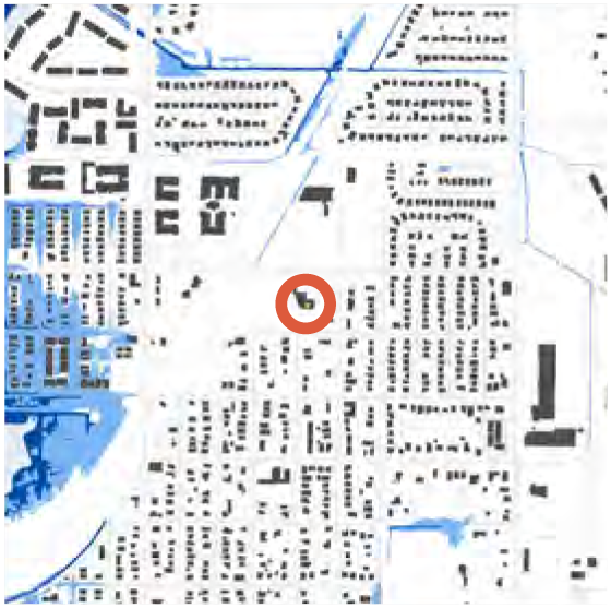 Map showing urban layout with buildings, roads, and waterways, highlighted by an orange circle in the center.