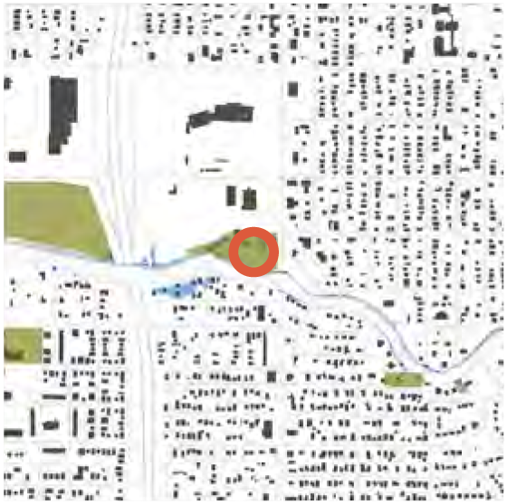 A map showing a river running through an area with buildings, highlighted by a red circle indicating a specific location.
