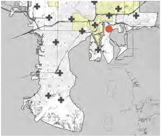 A historical map of an area with marked features and a highlighted location indicated by a red dot.