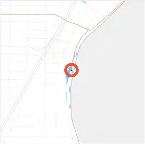 A map showing a body of water with a highlighted location marker near the shoreline.
