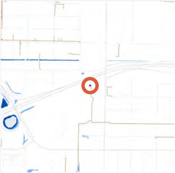 A map showing a circular waypoint marked in red at an intersection with surrounding roads and waterways.
