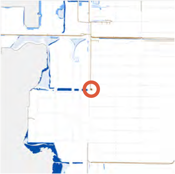 Map with a highlighted point marked in red, surrounded by street outlines and water features.