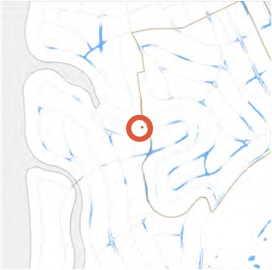 Map showing blue water features with a central red circle marking a specific location.