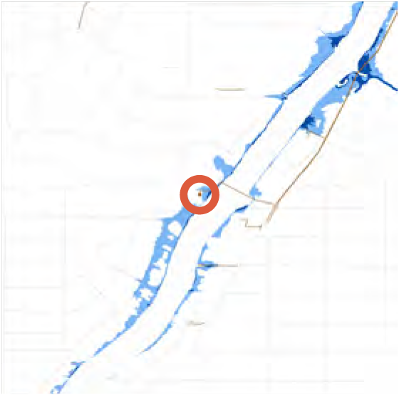 Map showing a river with highlighted areas in blue, centered on a red circle marking a specific location.