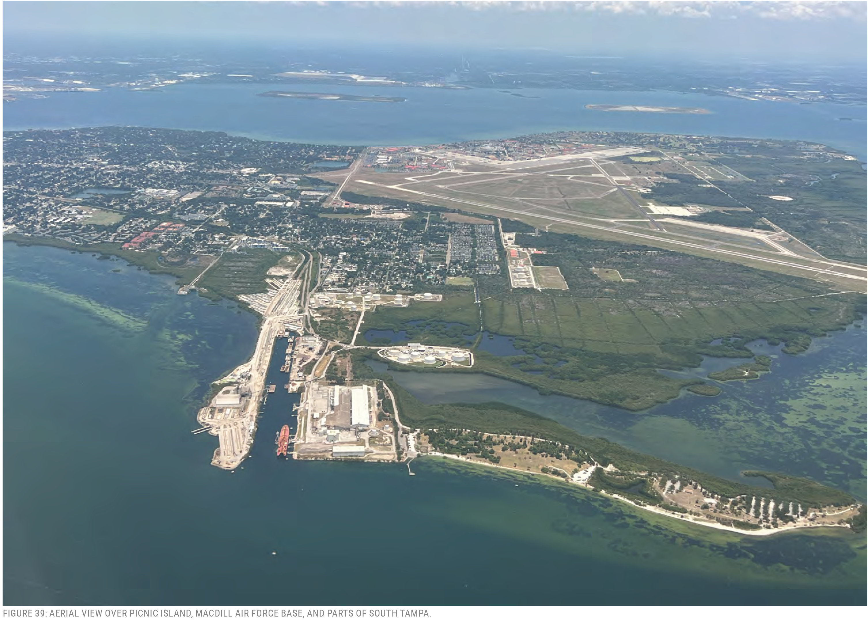 Aerial view of Picnic Island, MacDill Air Force Base, and parts of South Tampa, showcasing coastal and urban landscapes.