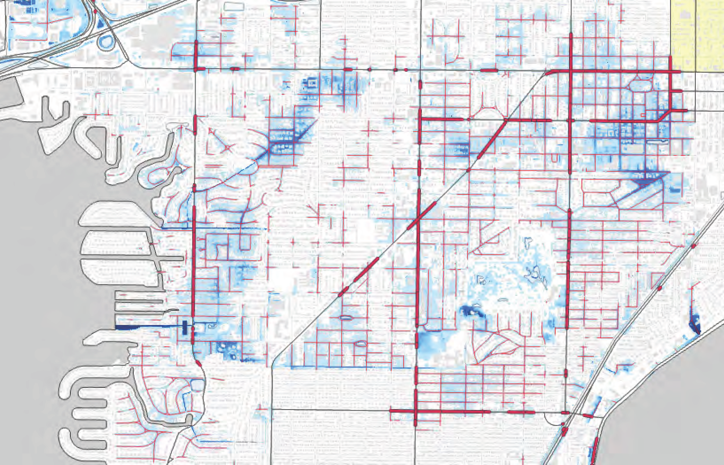 Map depicting urban areas with water features, showing blue and red lines representing different geographic or infrastructural elements.