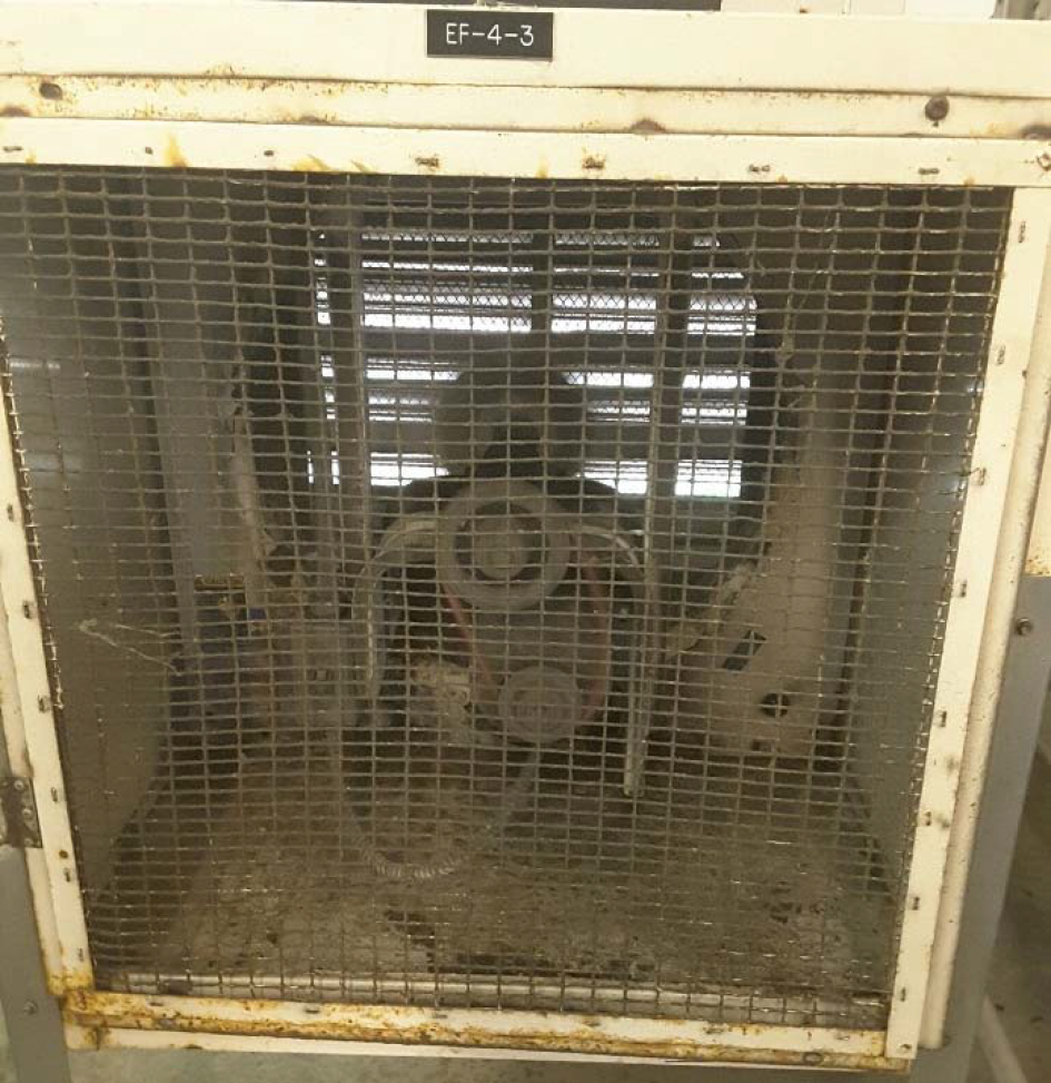 A rusted, metal grid enclosure with visible machinery inside, labeled 'EF-4-3', suggesting it’s part of an industrial or ventilation system.