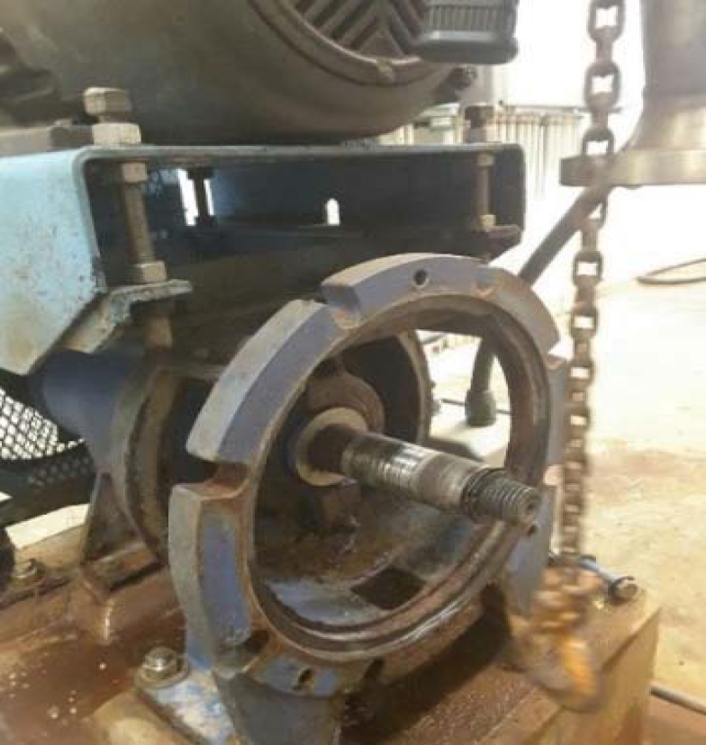 Close-up of a mechanical pump interior showing rotor and drive shaft details, with some rust and wear visible.