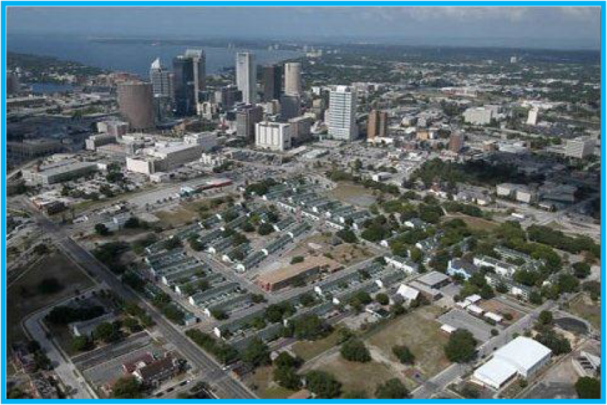 Aerial view of a city skyline with modern skyscrapers and residential areas, showcasing urban development and landscape.