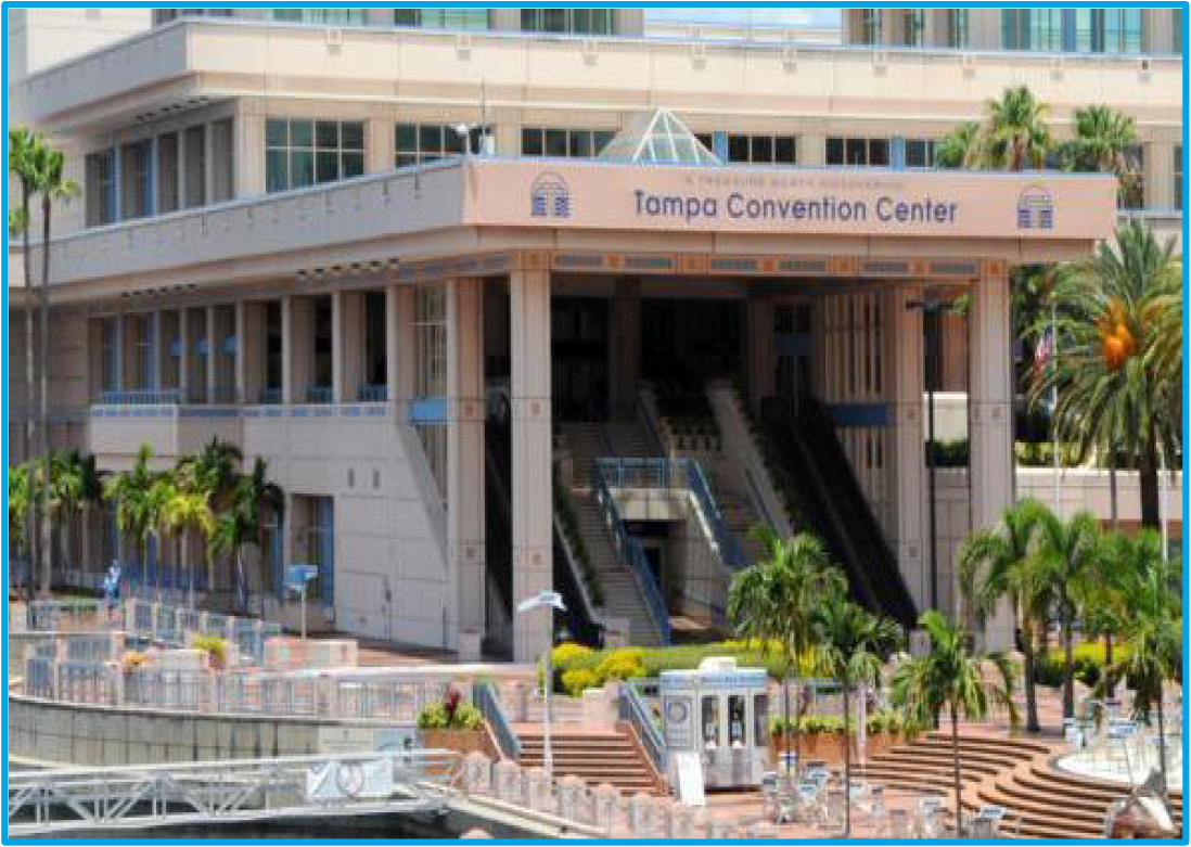 Exterior view of the Tampa Convention Center, featuring entrance stairs and surrounding palm trees.